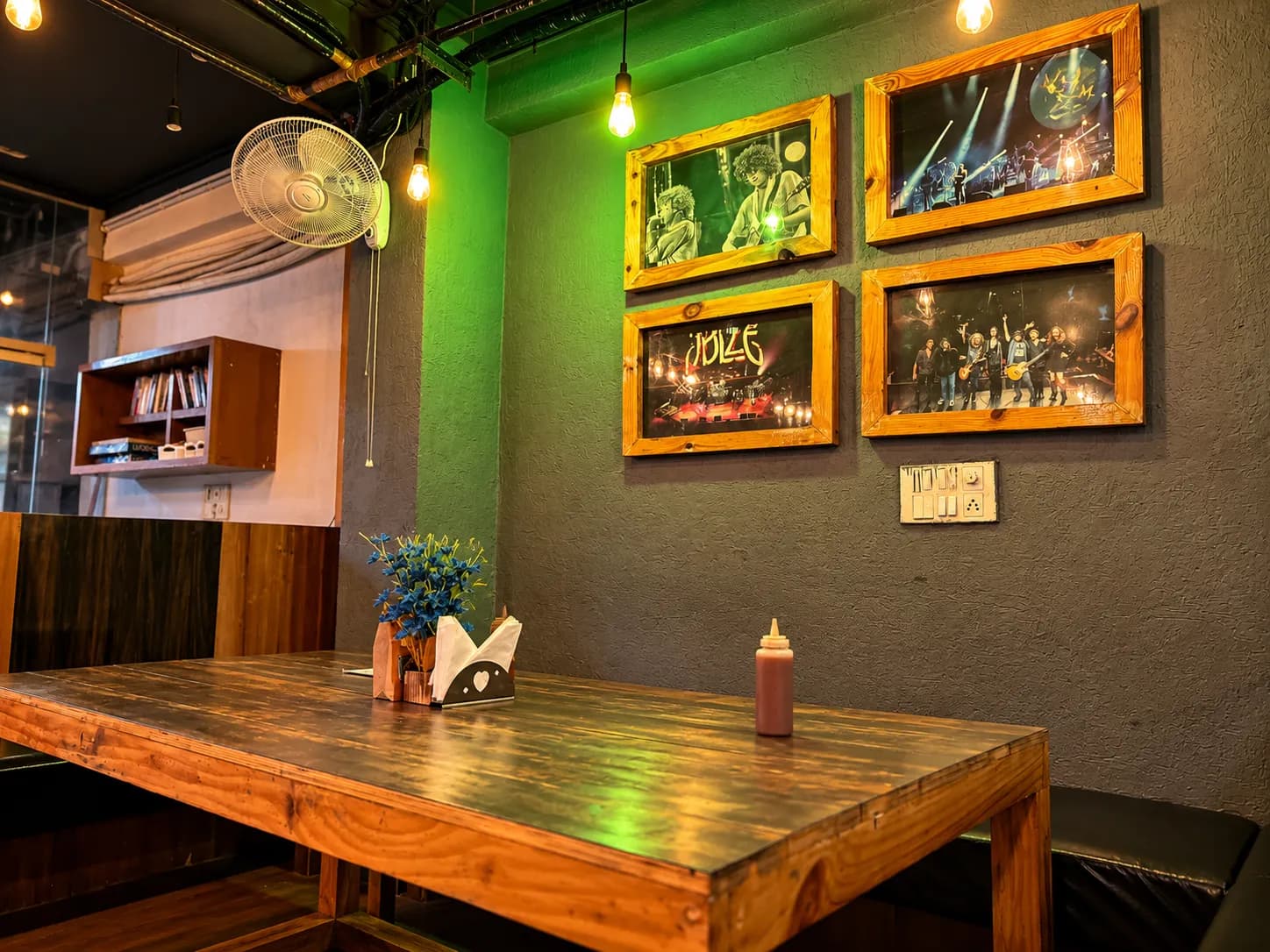 Concert photos in wooden frames above a wooden table